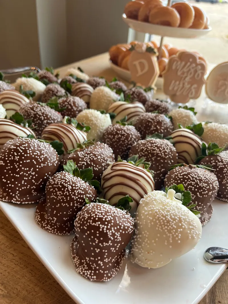 Bridal shower platter of chocolate-covered strawberries with white nonpareils and drizzles by A Touch of Chocolate